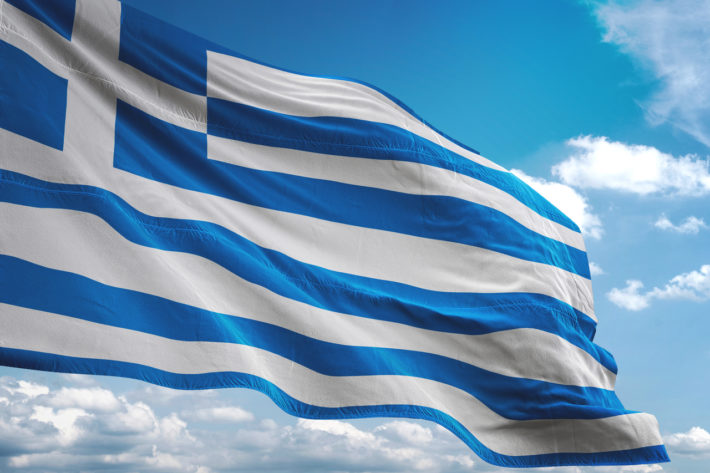 Greece flag waving cloudy sky background